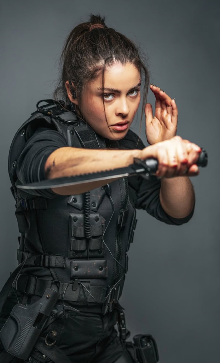 Florence Oliveira in tactical gear holding a knife